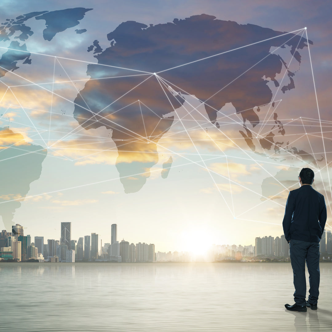 a man looking at a city skyline and world map