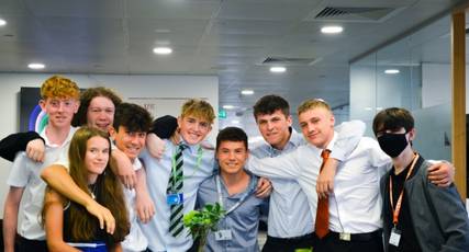 A group of students stood with their arms around one another