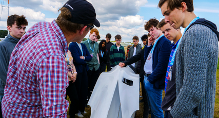 Engineering students learning from a tutor outside