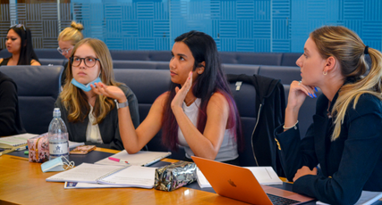 Law students sat around a table in discussion