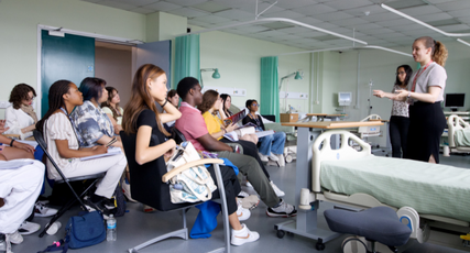 Psychology students sat in a ward listening to another student speaking