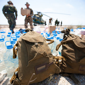 military deploying international aid from a helicopter